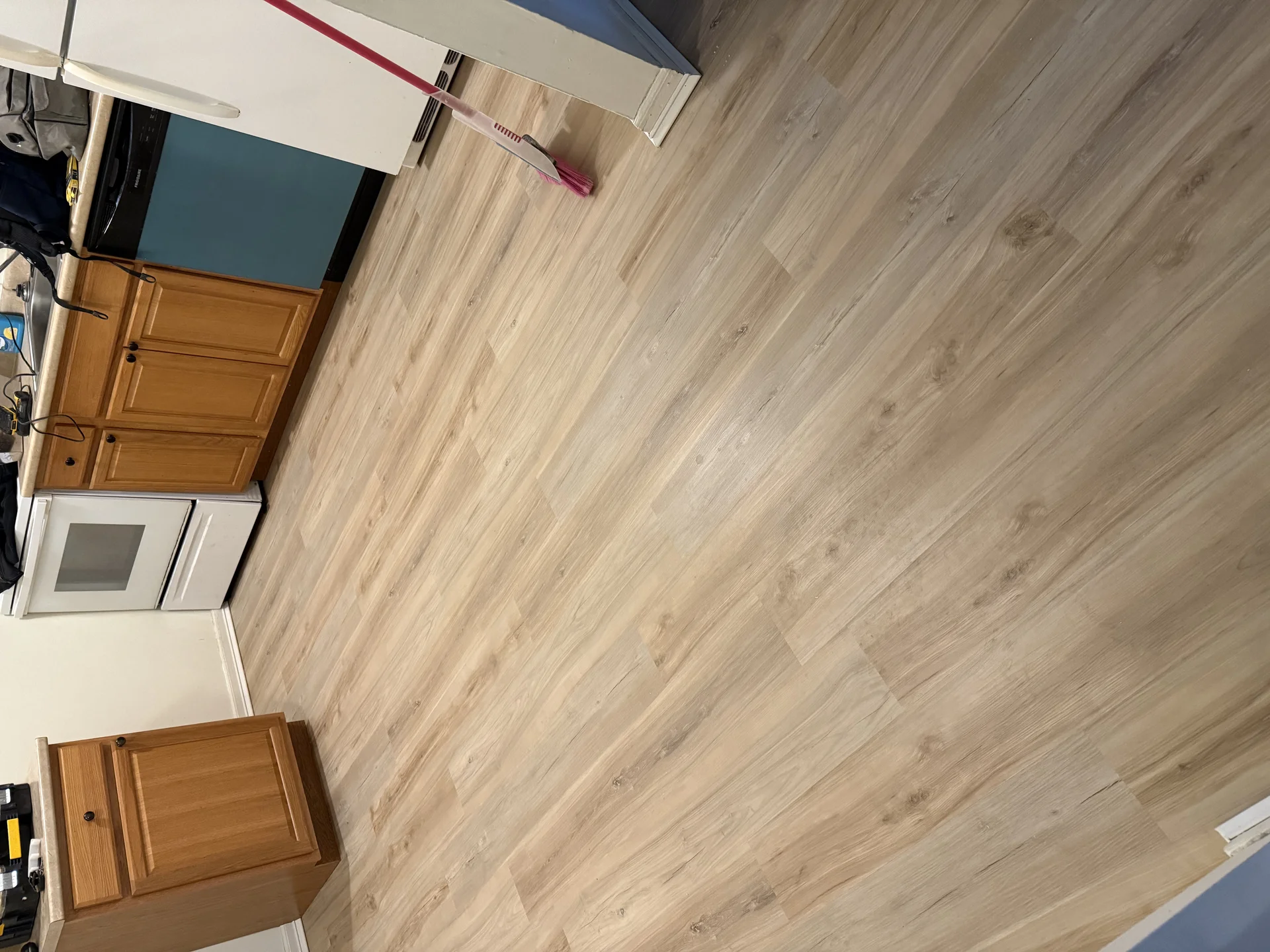 Wood-look vinyl plank flooring installed in a kitchen floor remodel by SF Construction in MetroWest, MA