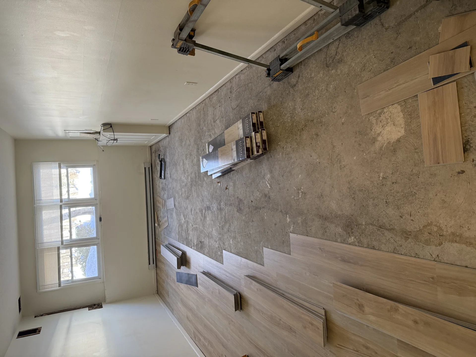 Kitchen renovation in progress with vinyl plank flooring and tile backsplash installation by SF Construction in Framingham, M
