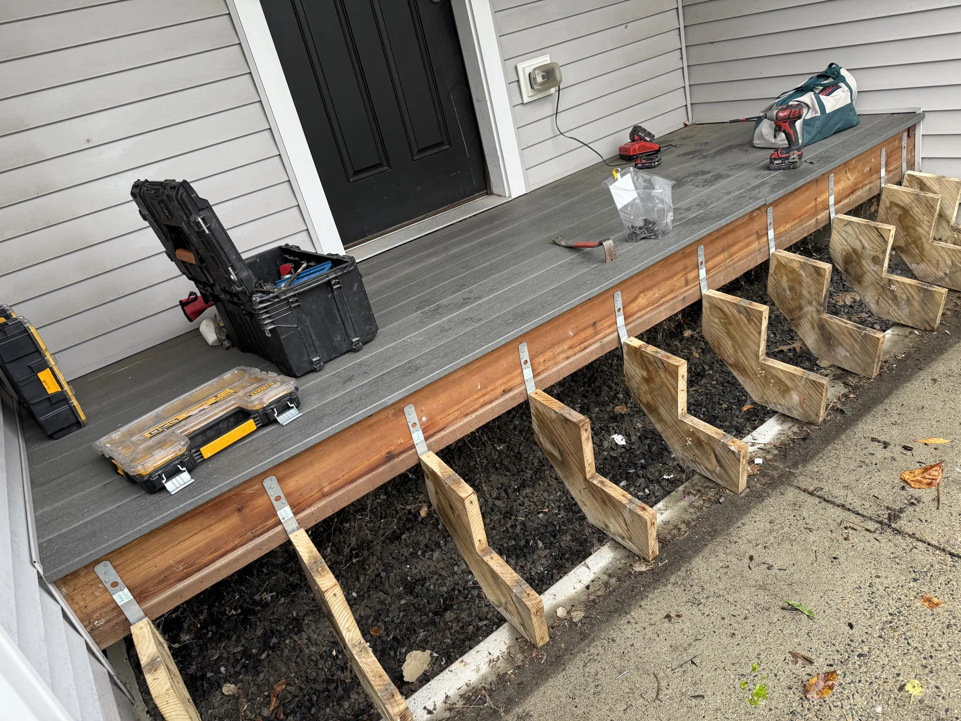Wooden raised garden bed construction with metal brackets and soil fill by SF Construction in Marlborough, MA