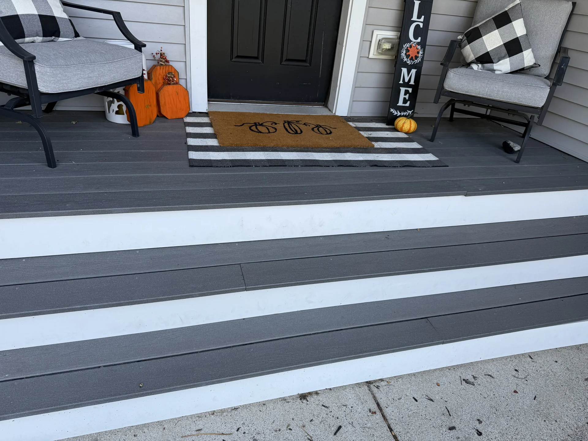 Gray and white striped vinyl plank flooring installed on front porch deck by SF Construction in Northborough, MA