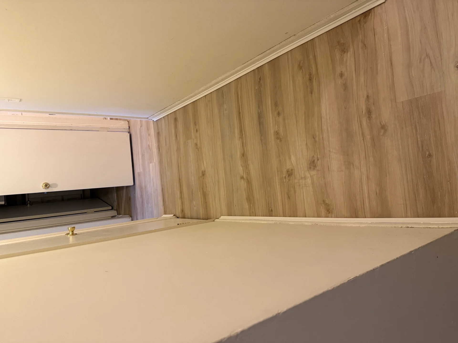 Vinyl plank flooring installation in room with wood-grain pattern and trim work by SF Construction in Northborough, MA
