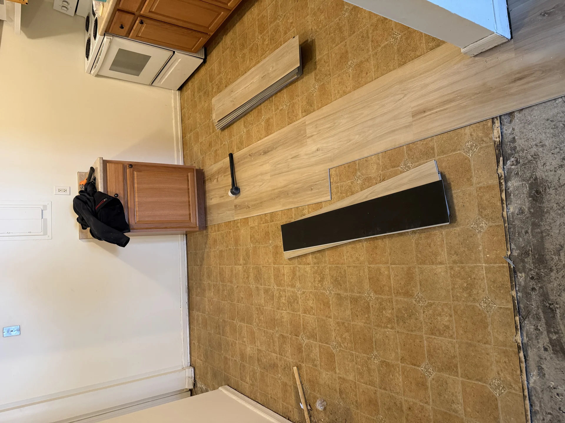 Kitchen renovation with vinyl plank flooring installation over existing tile by SF Construction in Northborough, MA