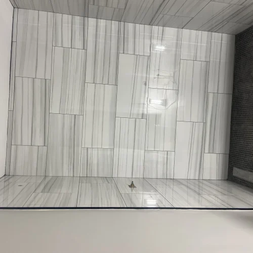 Modern bathroom shower with gray wood-grain tile walls and floor installation by SF Construction in Northborough, MA