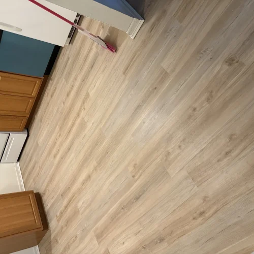 Wood-look vinyl plank flooring installed in a kitchen floor remodel by SF Construction in MetroWest, MA