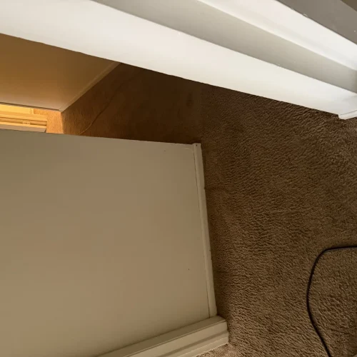 Custom built-in shelving with textured wall finish and recessed lighting installation by SF Construction in Westborough, MA
